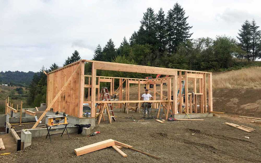 A picture of a construction job site with Chuck, the owner of Adapt Digital Solutions standing inside the building